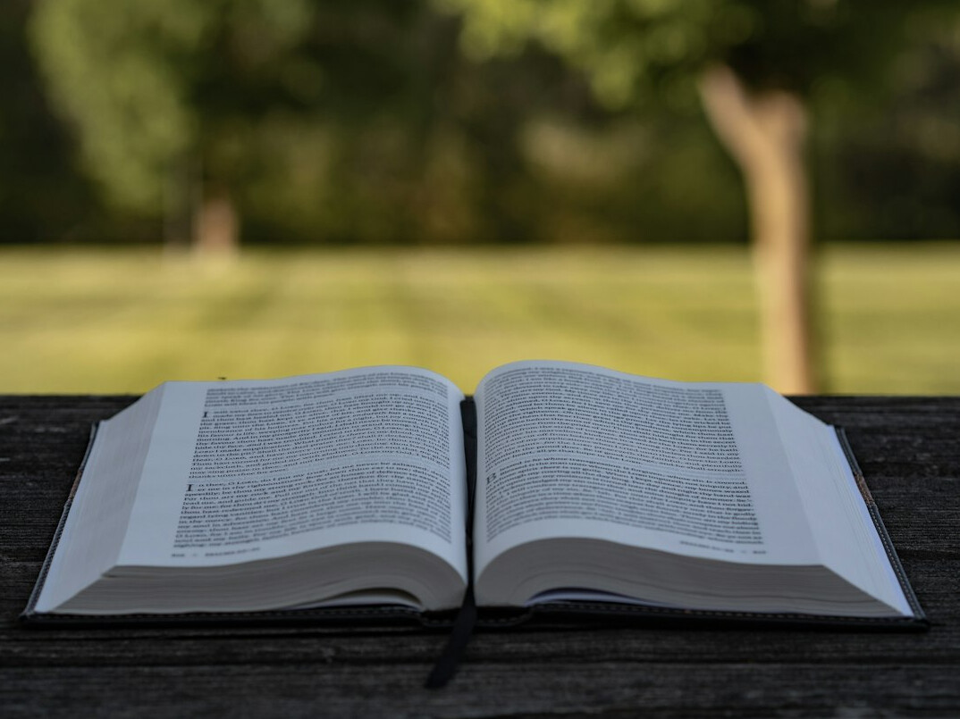 Open book on a table with pages turning